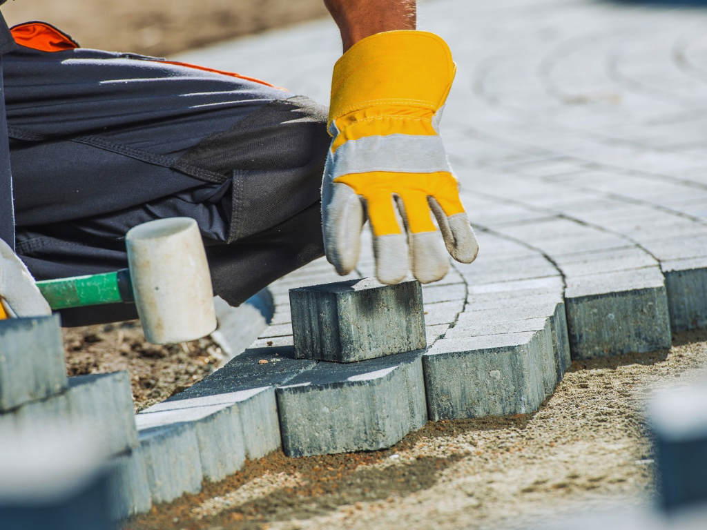A man building or paving a driveway