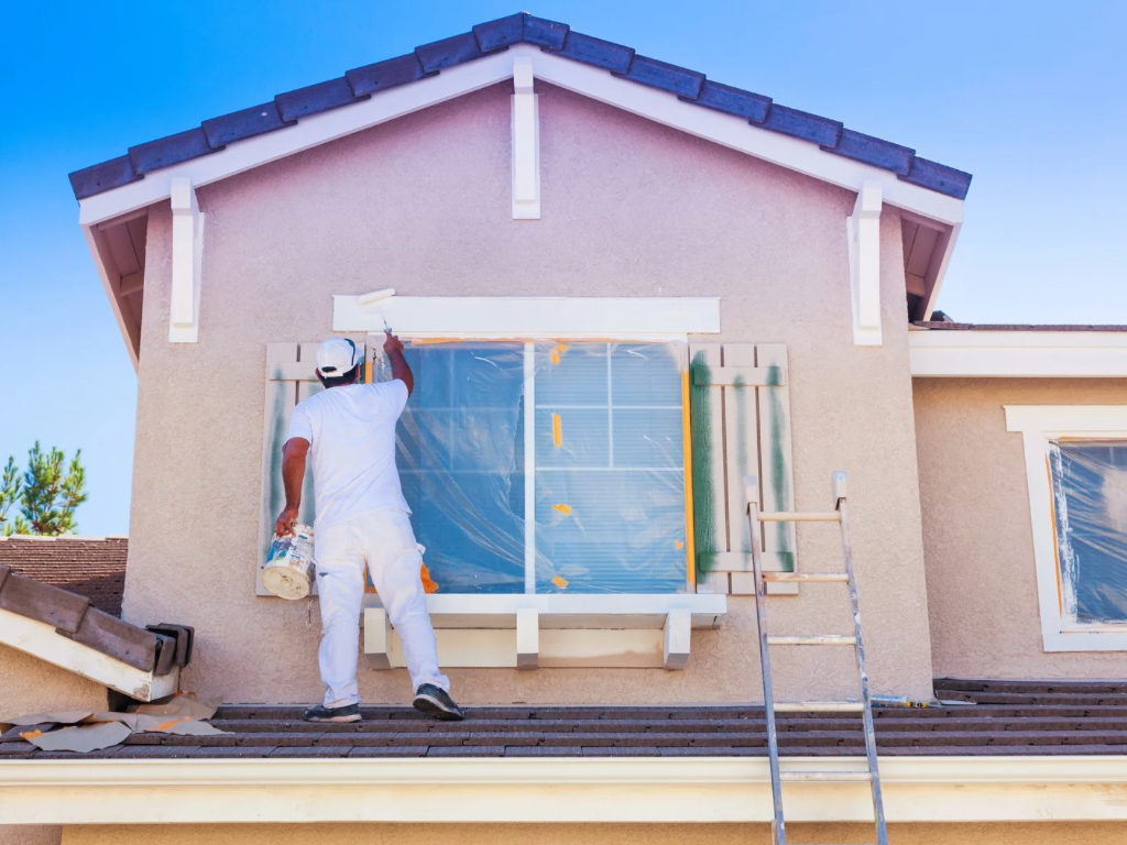 A man painting a house